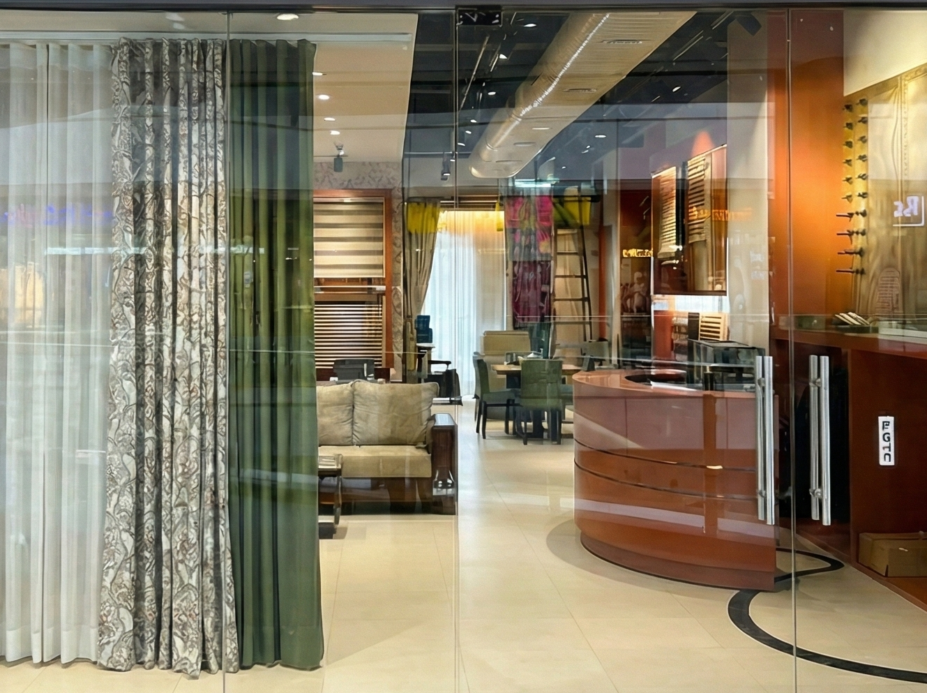 Storefront of The Curtain Store with interior display of curtains and furniture.